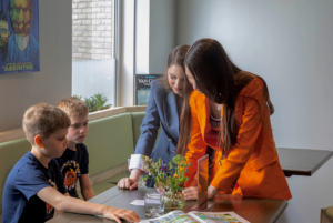 Hadley and Delany work with two boys at the Van Gogh house